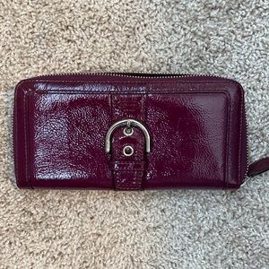 Coach purple buckle zip wallet.  Outside looks amazing, inside has some wear